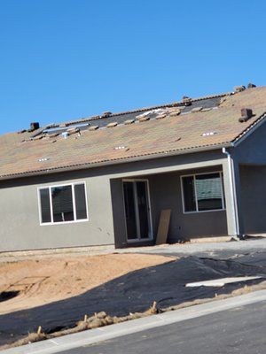 A house that is being built with a lot of windows