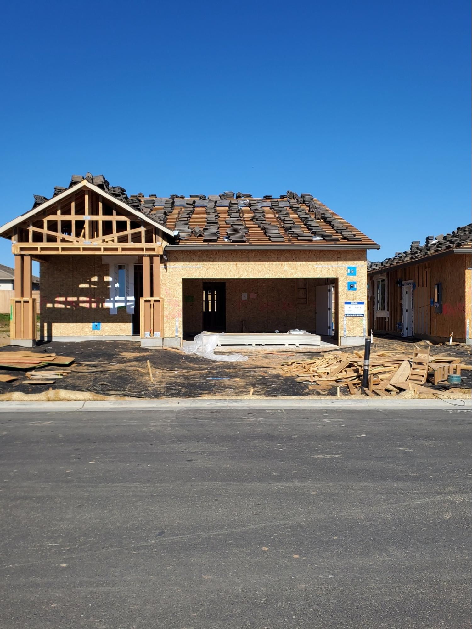 A house that is being built with a blue sky in the background
