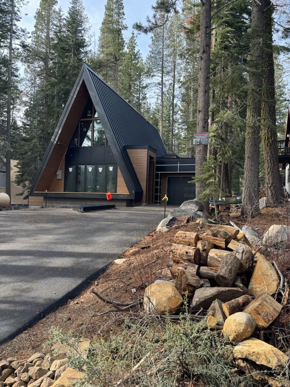 A triangle shaped house in the middle of a forest