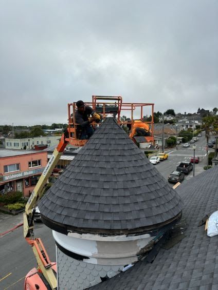A man is working on the roof of a building