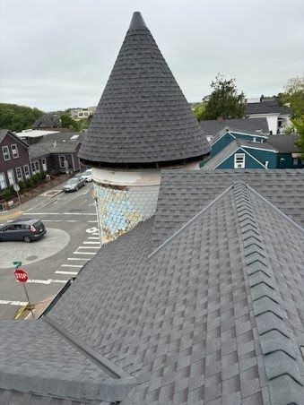 An aerial view of a roof with a cone on top of it.