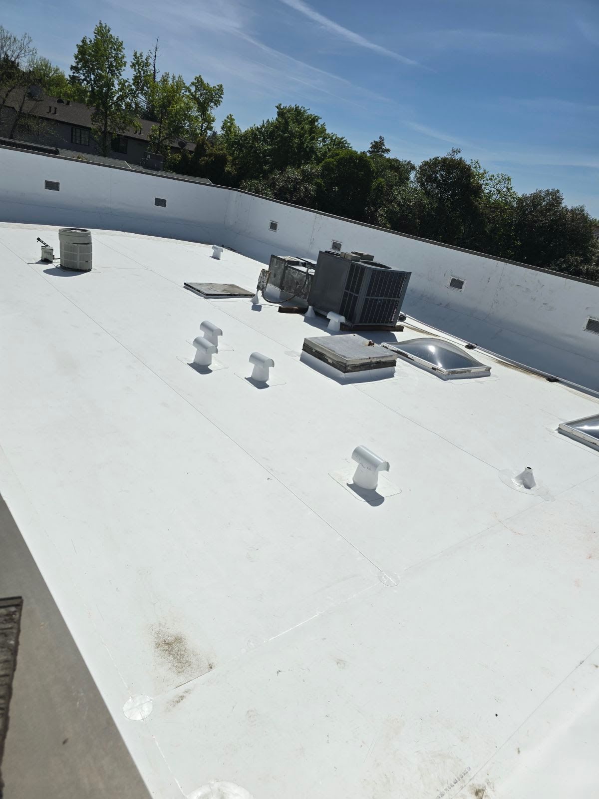 A white roof with a blue sky in the background