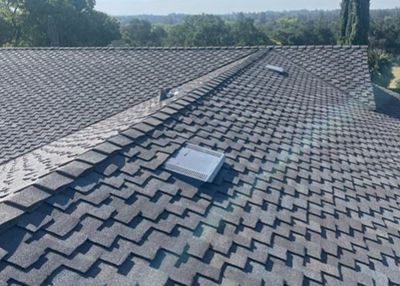 A close up of a roof with a skylight on it.