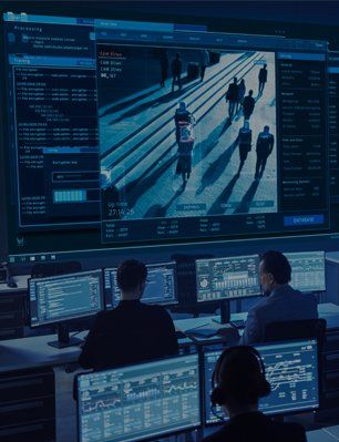 Room of men monitoring monitors display security cameras and data