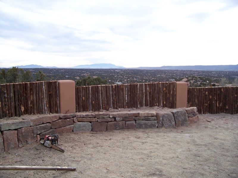 Contemporary coyote fence with stucco pillars