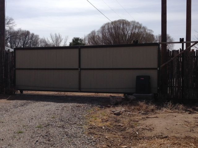 A fence with a gate in the middle of it