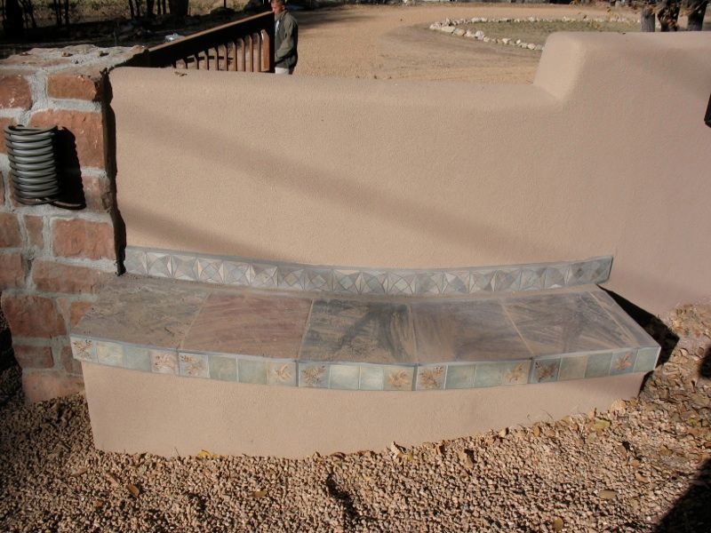 Tiled sitting area on Tesuque wall