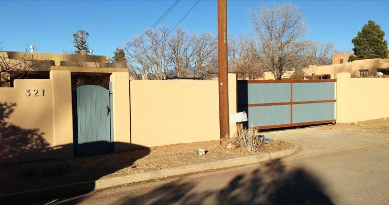 Stuccoed wall with automatic sliding gate