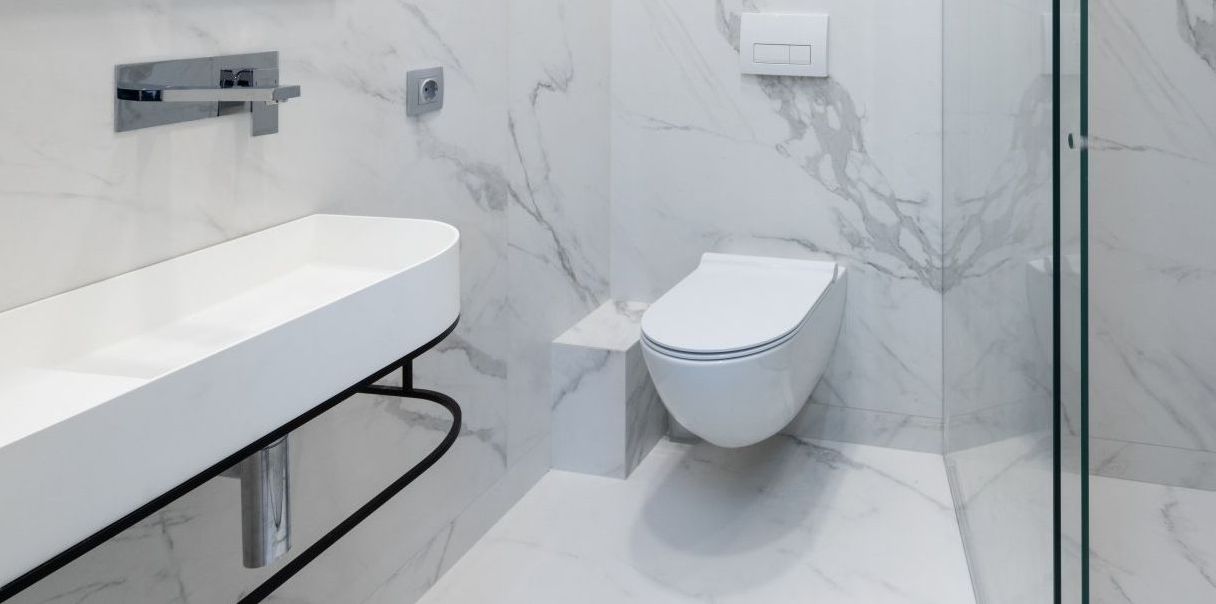 A bathroom with a toilet , sink , and shower.