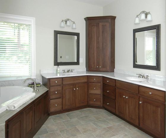 Cabinets — Light Bathroom With Two Sinks And Cabinet in Bristol, CT