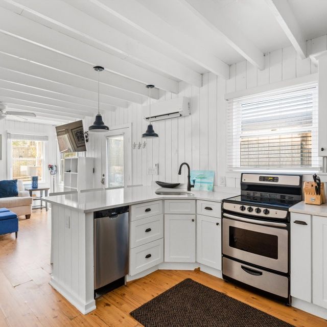 A kitchen with stainless steel appliances and white cabinets