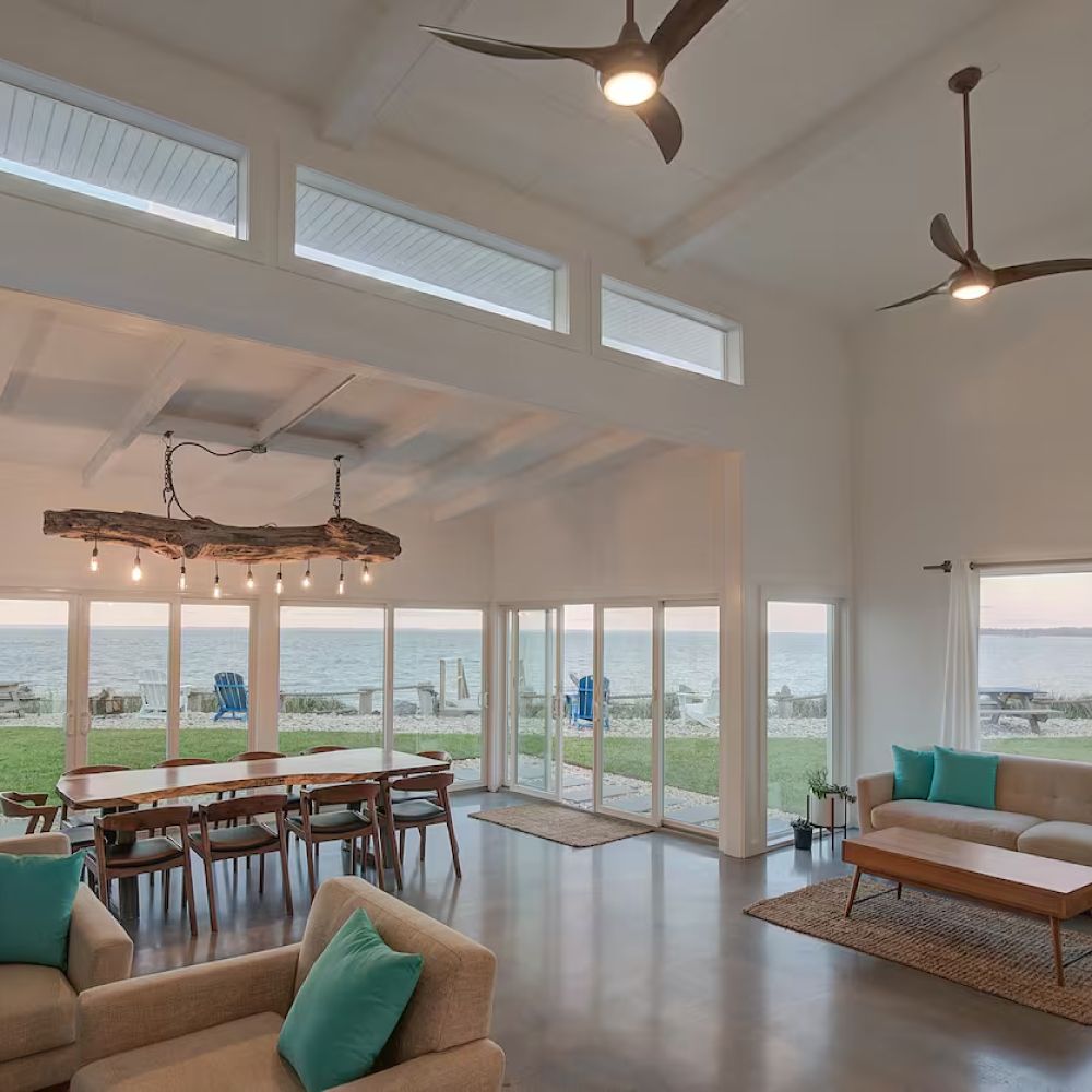 A living room with a couch a table and a ceiling fan