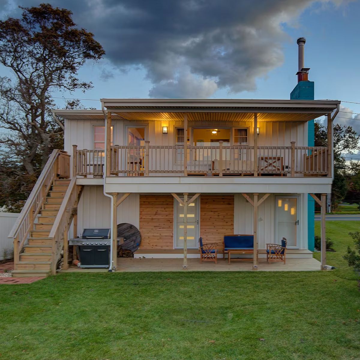 A house with a large deck and stairs leading up to it