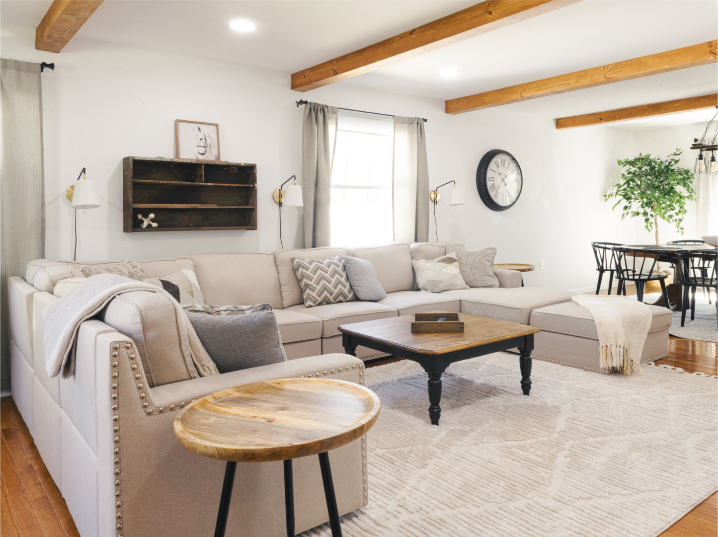A living room with a large sectional couch and a coffee table.