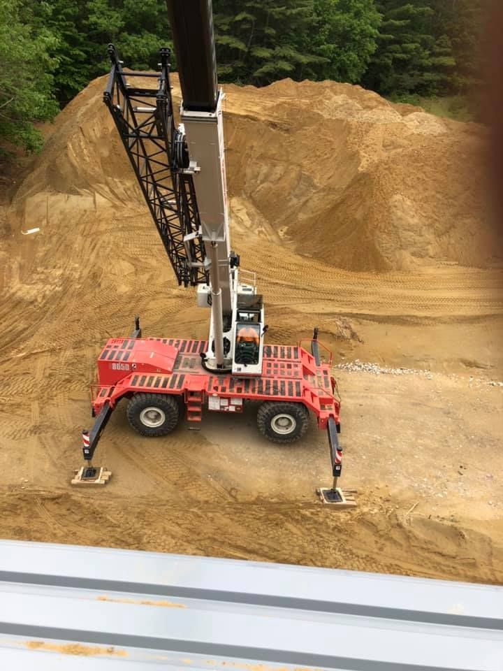 A crane in use at a newly excavated construction site