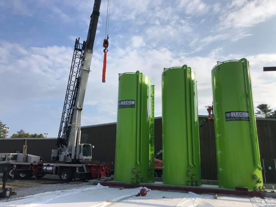 A crane truck is prepped to lift heavy materials at a construction site in Vermont