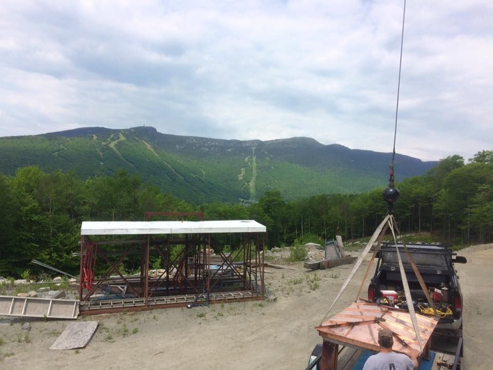 A Mayo Crane Rental crane is loaded up with materials at a Vermont construction site