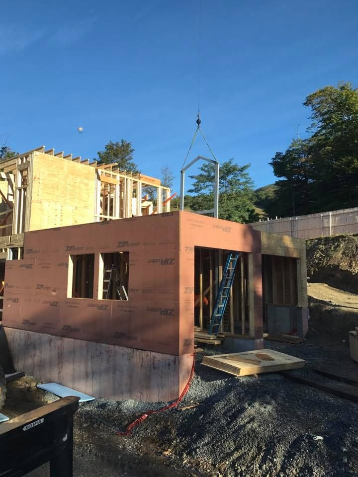 A piece of framing is lowered into place by a crane rented from Mayo Crane Rental, LLC