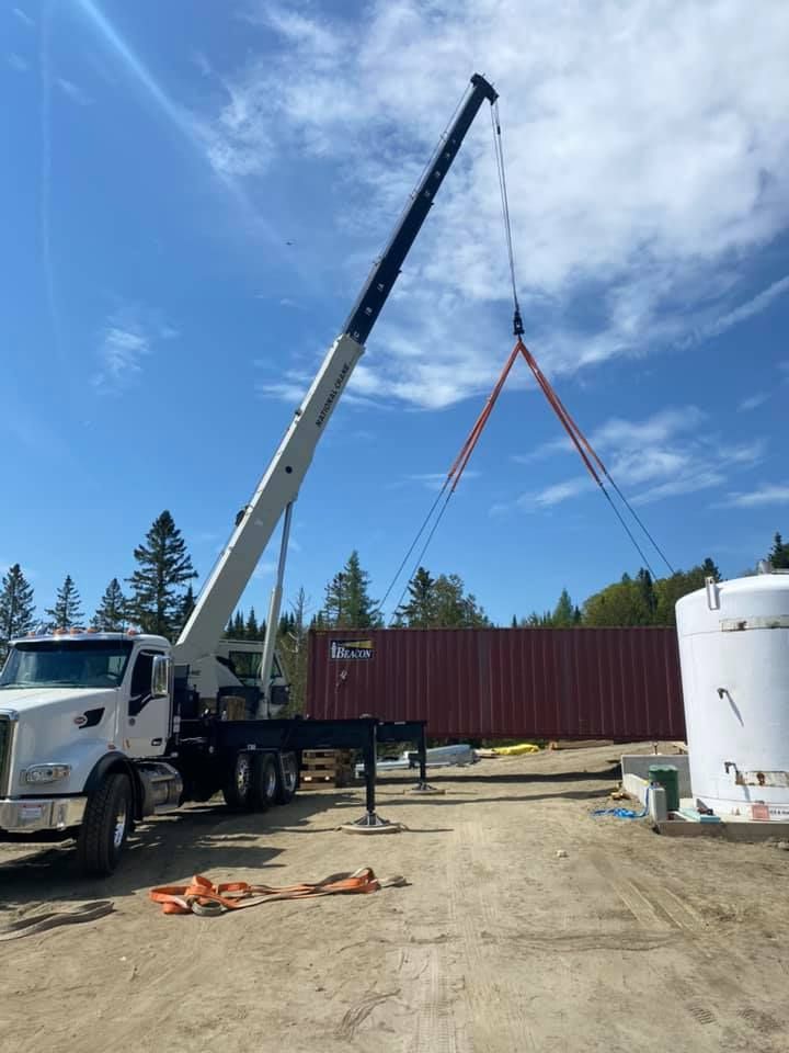 A large crane lifts a shipping container in Vermont
