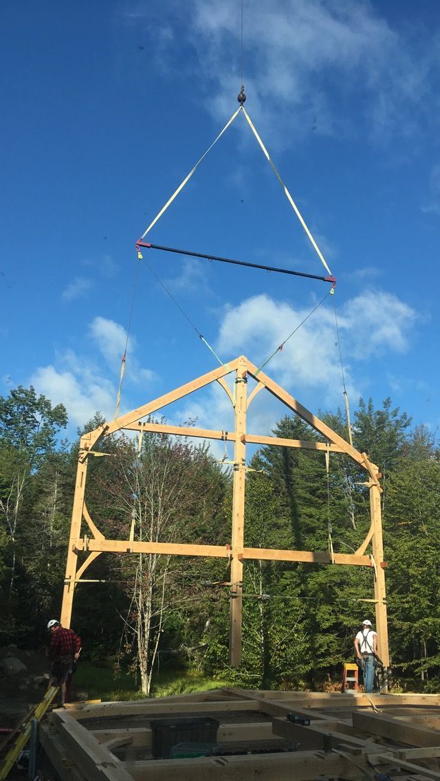 The pre-built frame of a home is placed by a crane