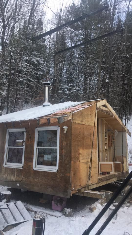 A shed is placed gently in its new location by a crane supplied by Mayo Crane Rental, LLC in Vermont