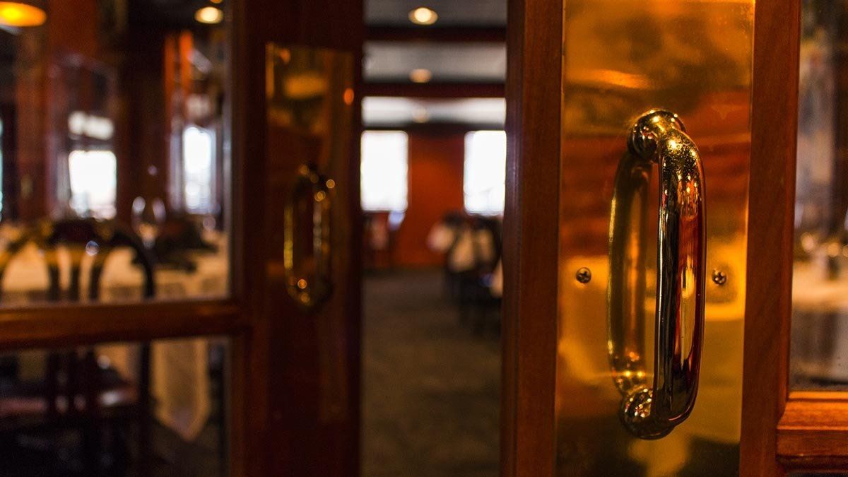 A close up of a door handle in a restaurant.