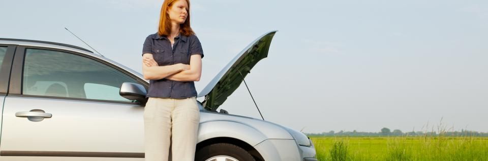 woman experiencing car engine trouble