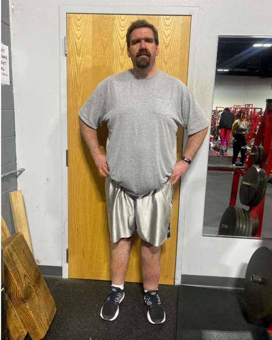 A man standing in front of a door in a gym