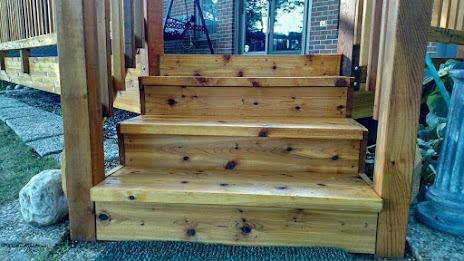 Wooden deck stairs with three steps, flanked by wooden posts.