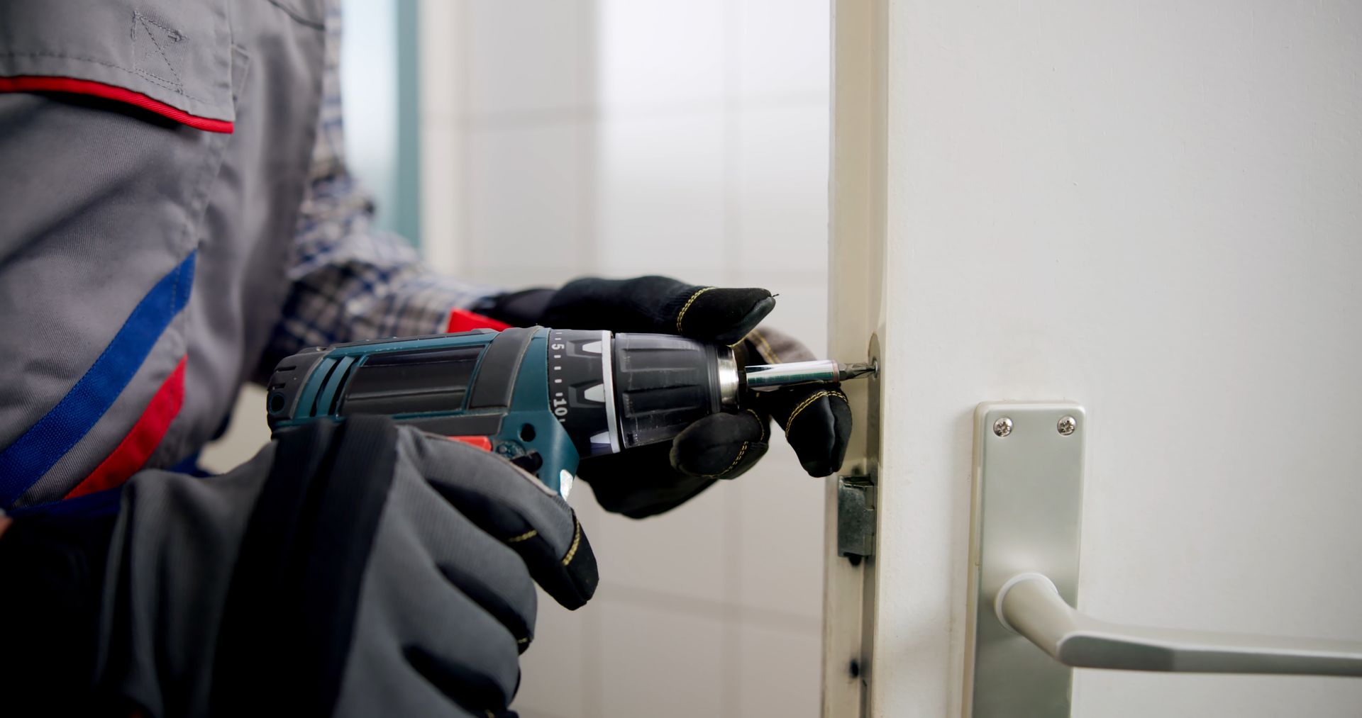 Experienced locksmith replacing a damaged door.