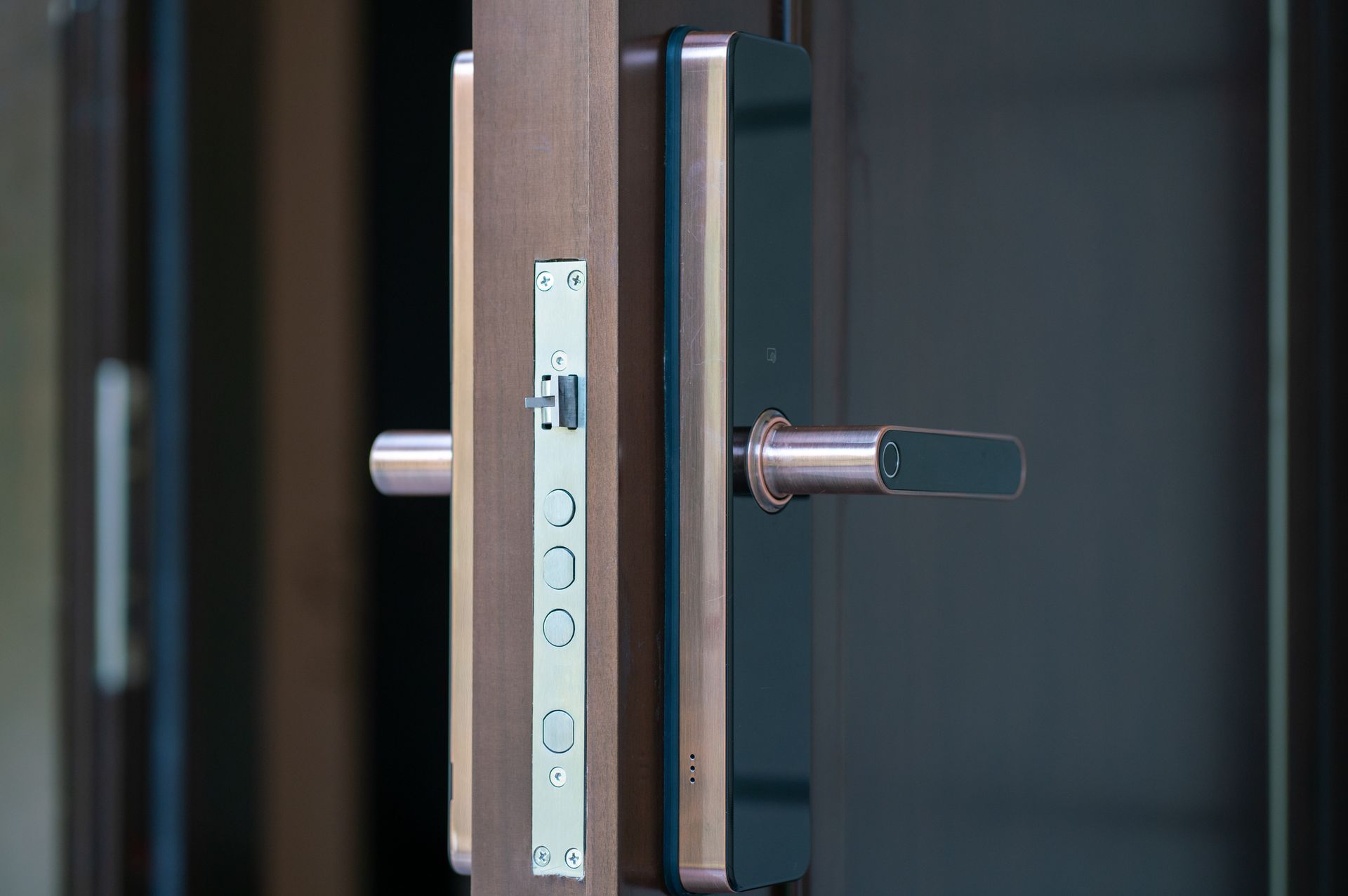 A close-up view of a modern door handle and lock mechanism.