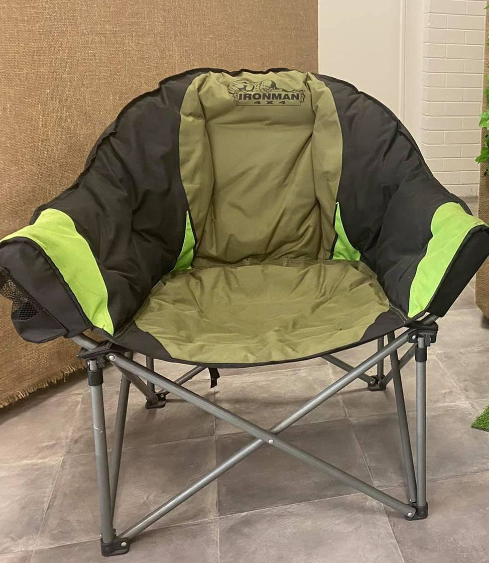 A Green and Black Folding Chair is Sitting on a Tiled Floor — Westlakes 4x4 Centre in Singleton, NSW