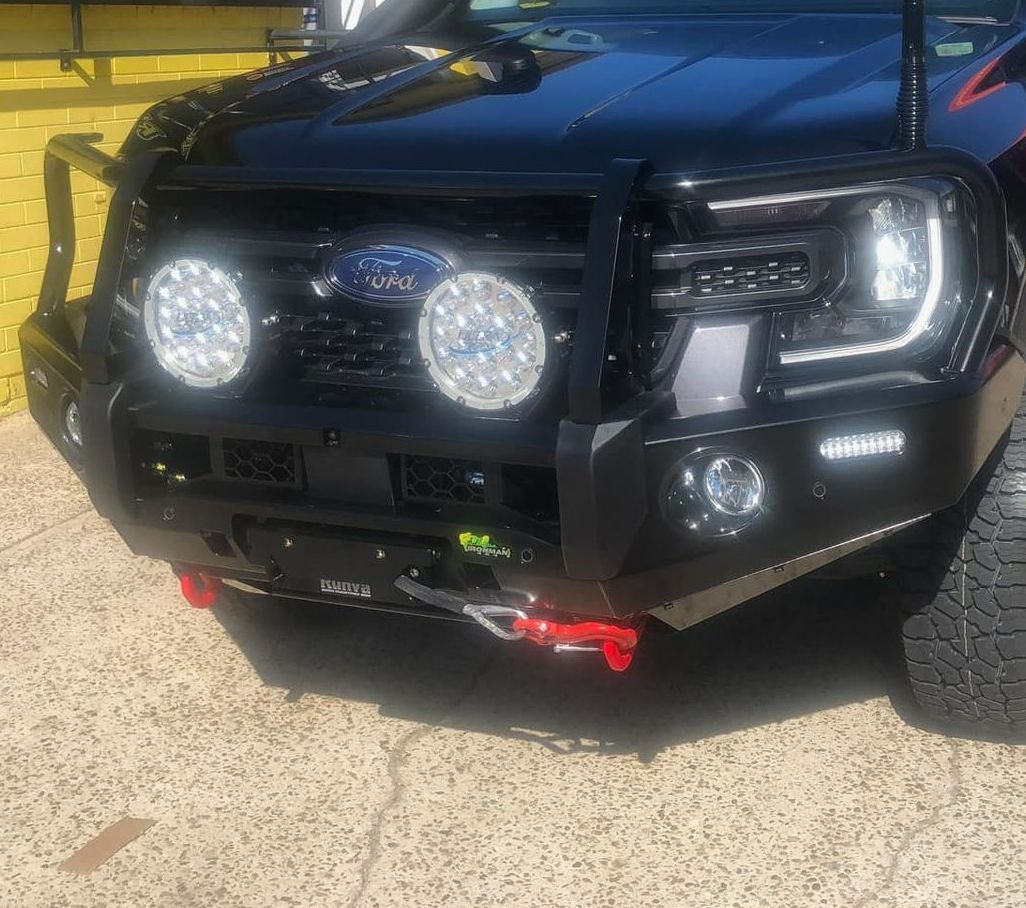 A Black Ford Truck is Parked on the Side of the Road — Westlakes 4x4 Centre in Newcastle, NSW
