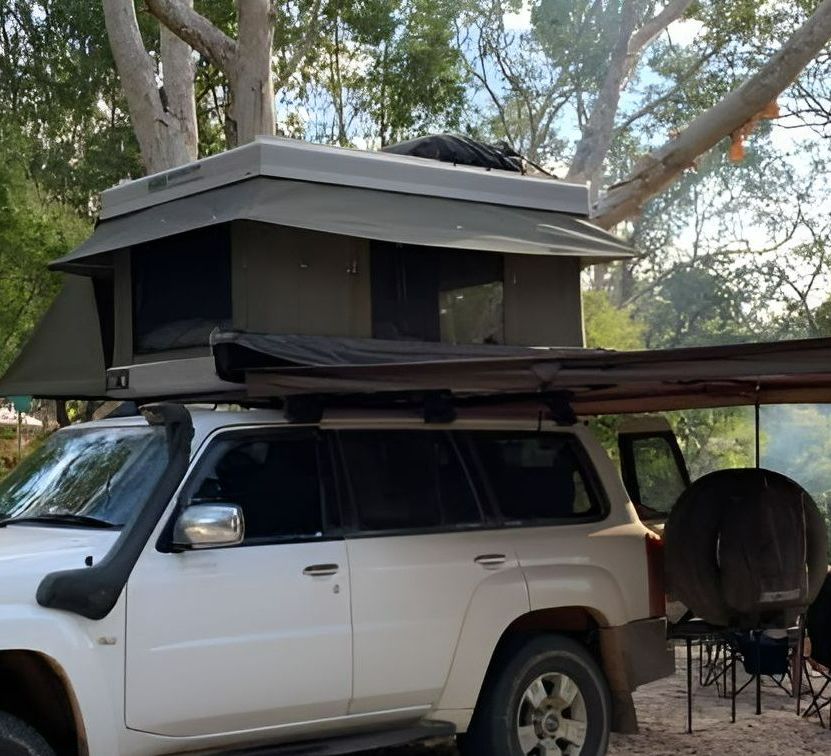 A White Suv With a Tent on Top of It — Westlakes 4x4 Centre in Newcastle, NSW
