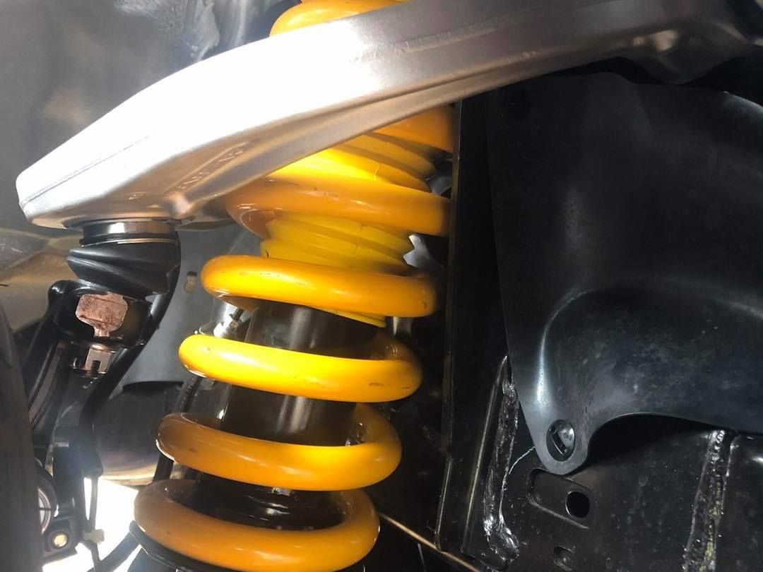 A Close Up of a Yellow Shock Absorber on a Car — Westlakes 4x4 Centre in Newcastle, NSW