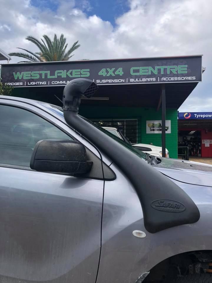 A Car With a Snorkel on Top of It is Parked in Front of a Store — Westlakes 4x4 Centre in Newcastle, NSW