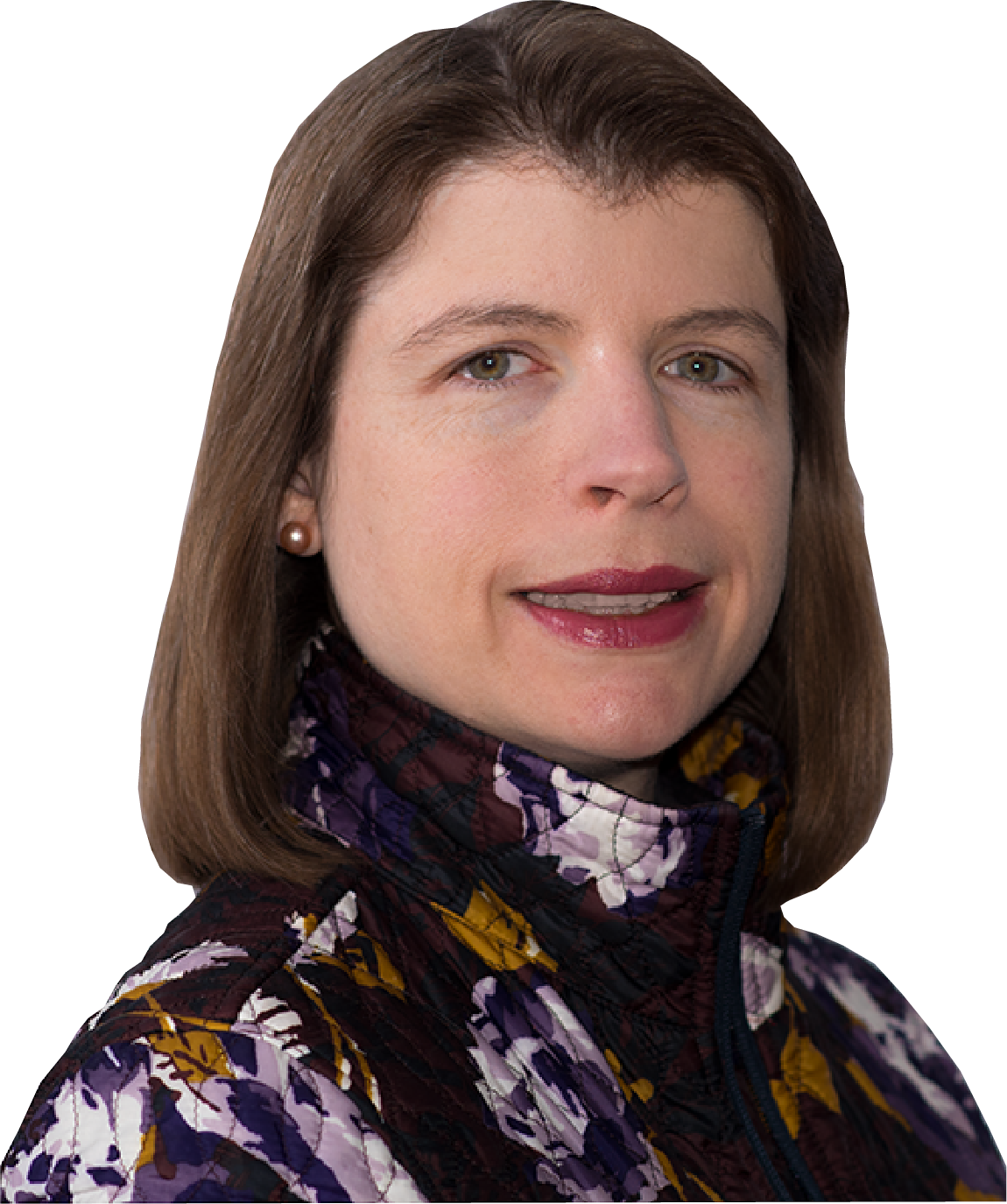 Woman with short brown hair, wearing a floral patterned jacket, smiling.