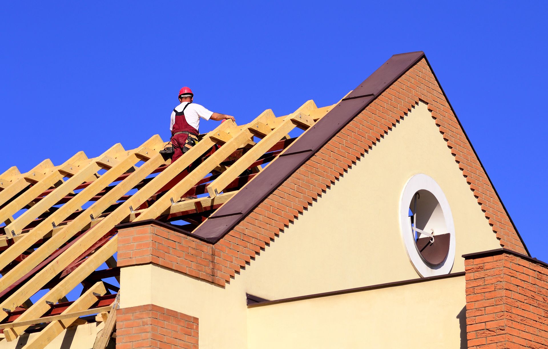 A man is replacing a new roof from an old one that was damaged and could not be restored.