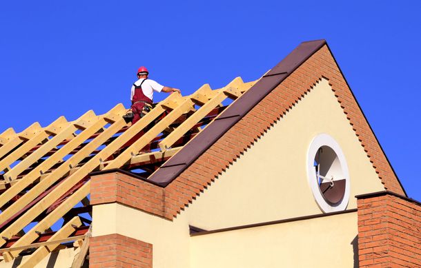 A man is replacing a new roof from an old one that was damaged and could not be restored.