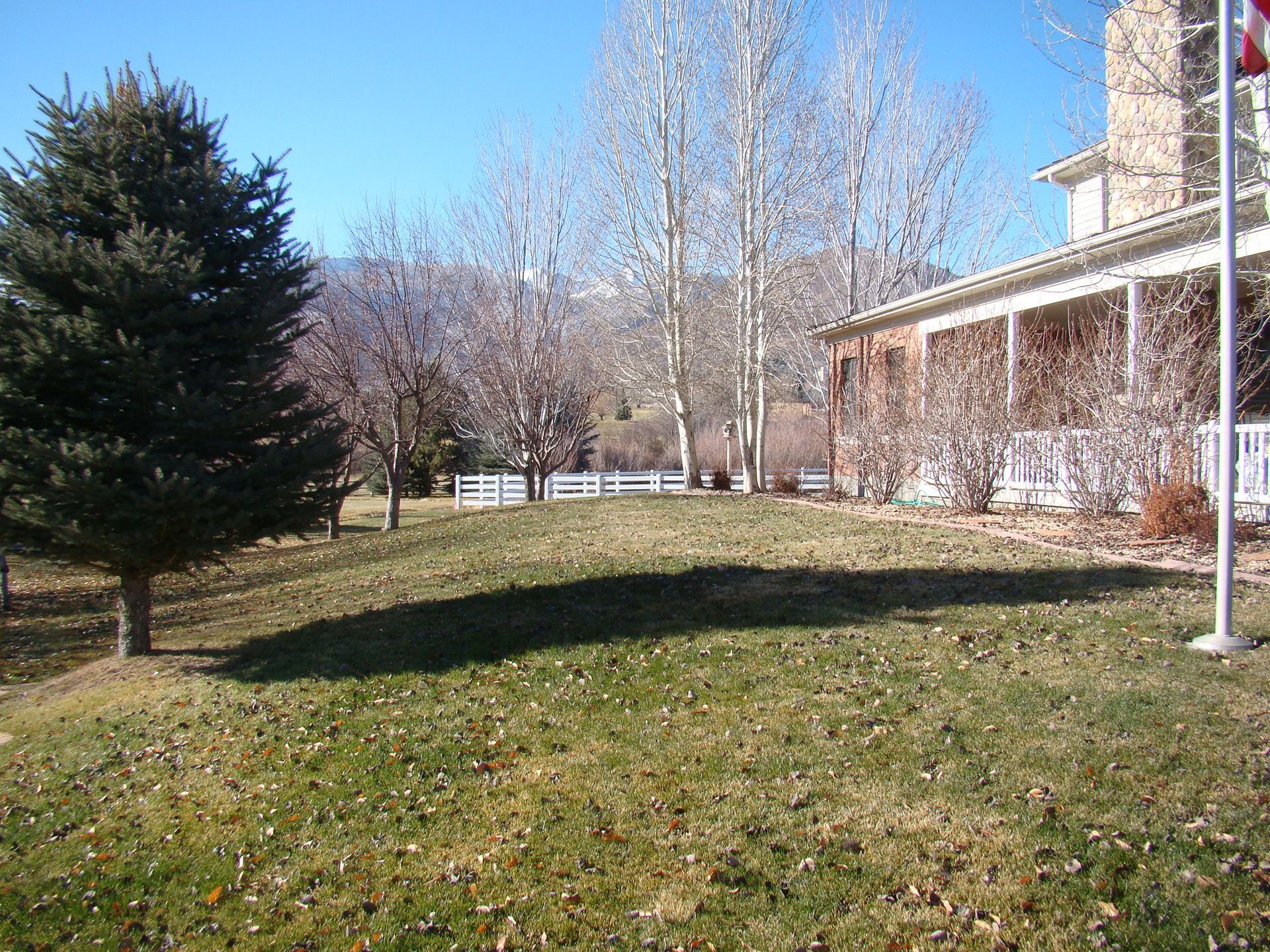 A large house with a flag pole in front of it