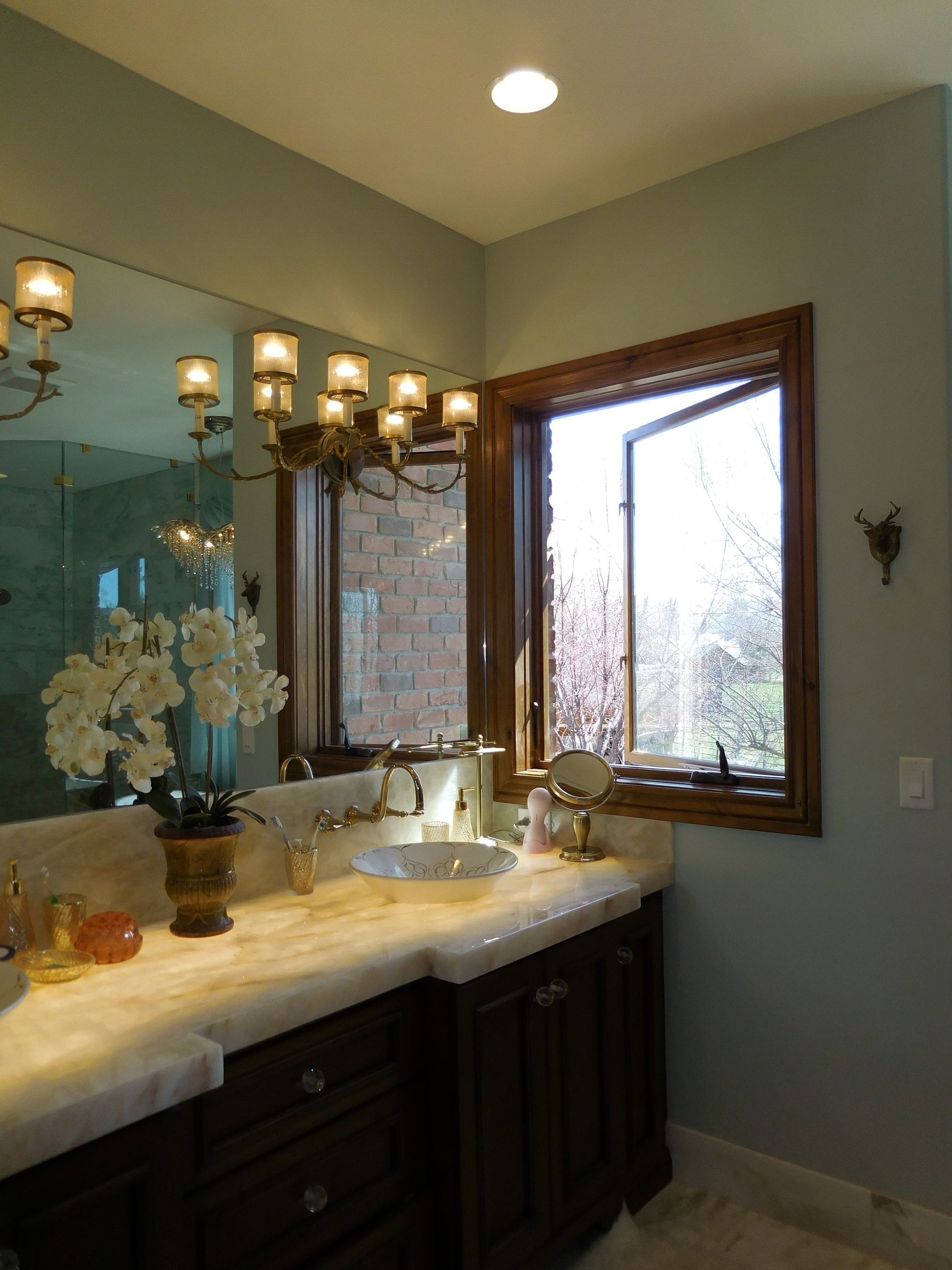 A bathroom with two sinks and a large mirror