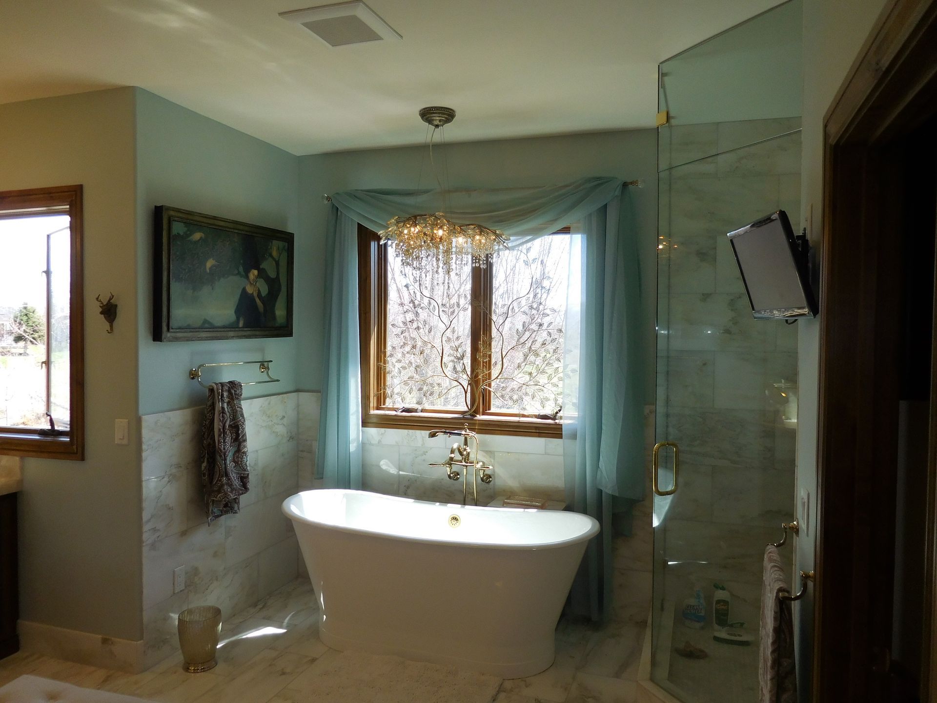 A bathroom with a bathtub and a window
