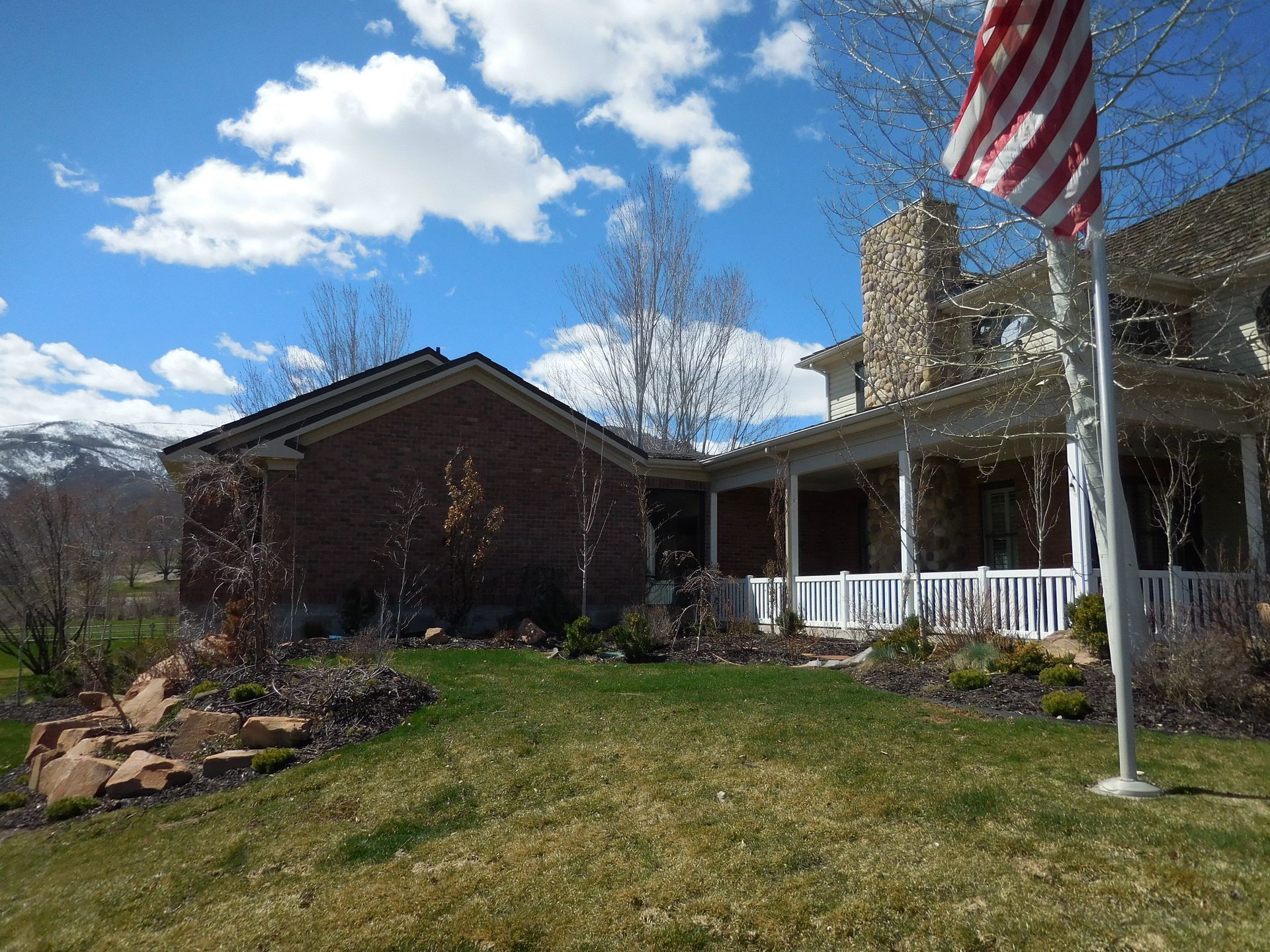 An american flag is flying in front of a house
