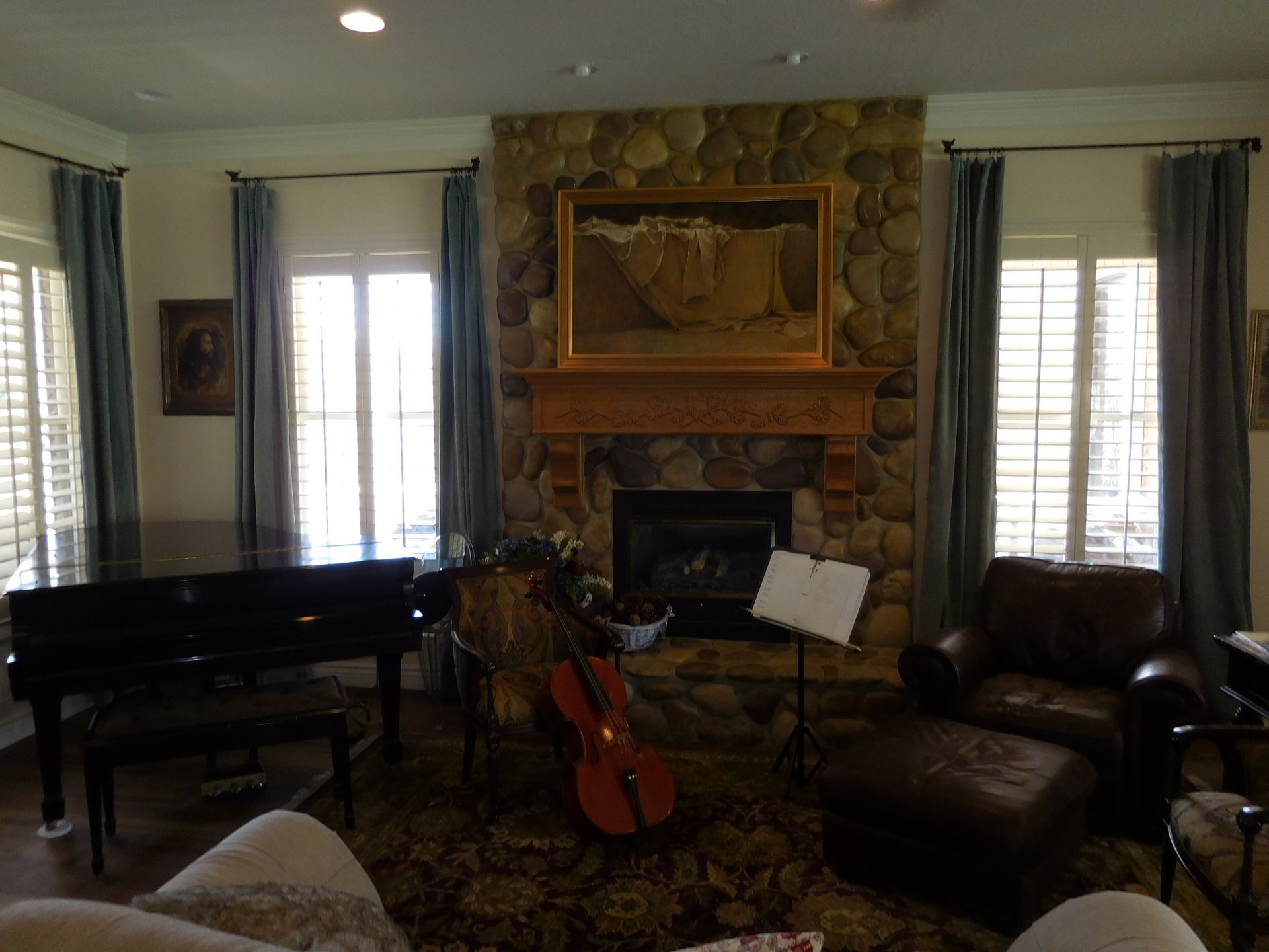 A living room with a fireplace and a piano