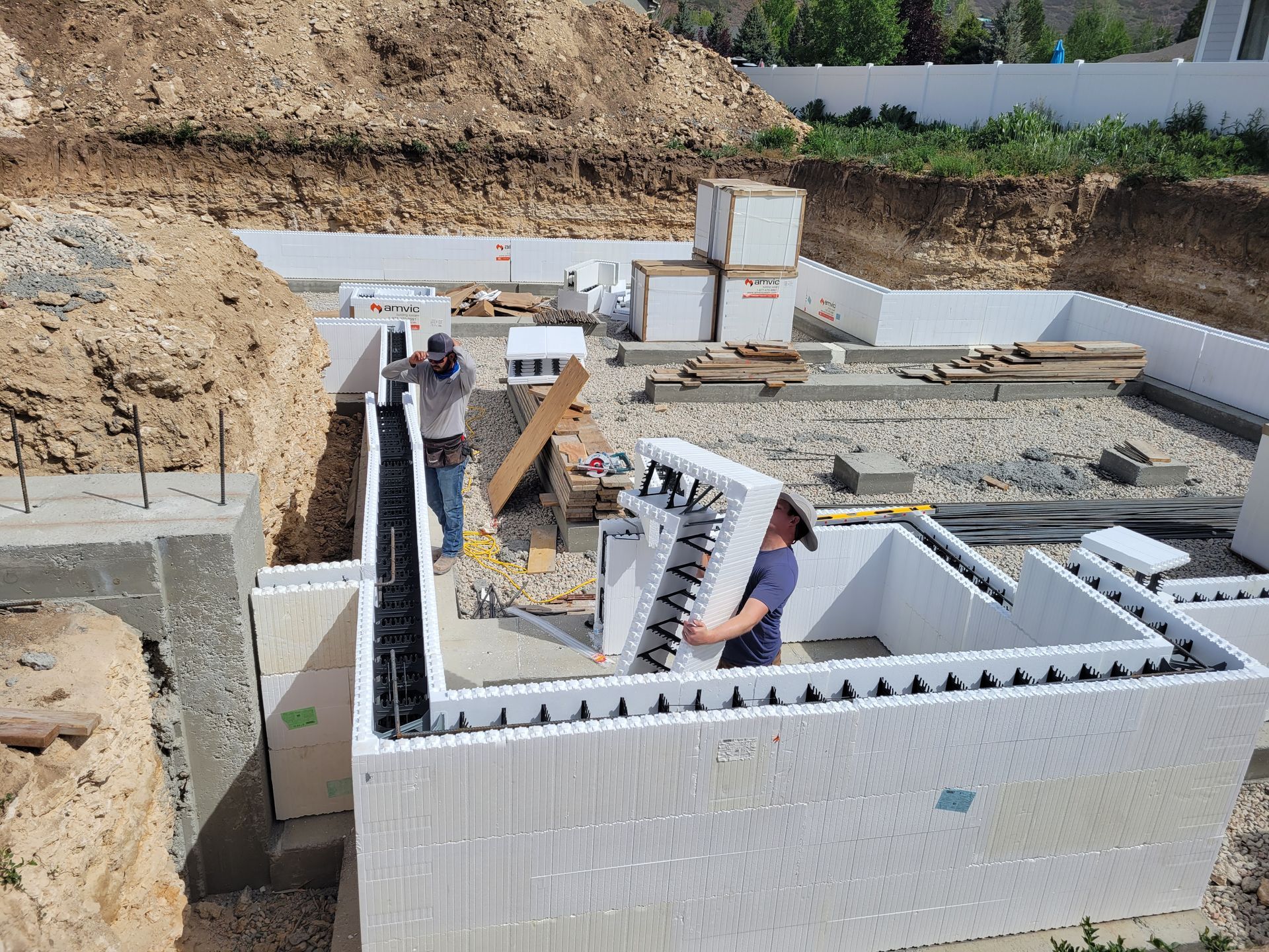 A man is holding a piece of styrofoam in a construction site.