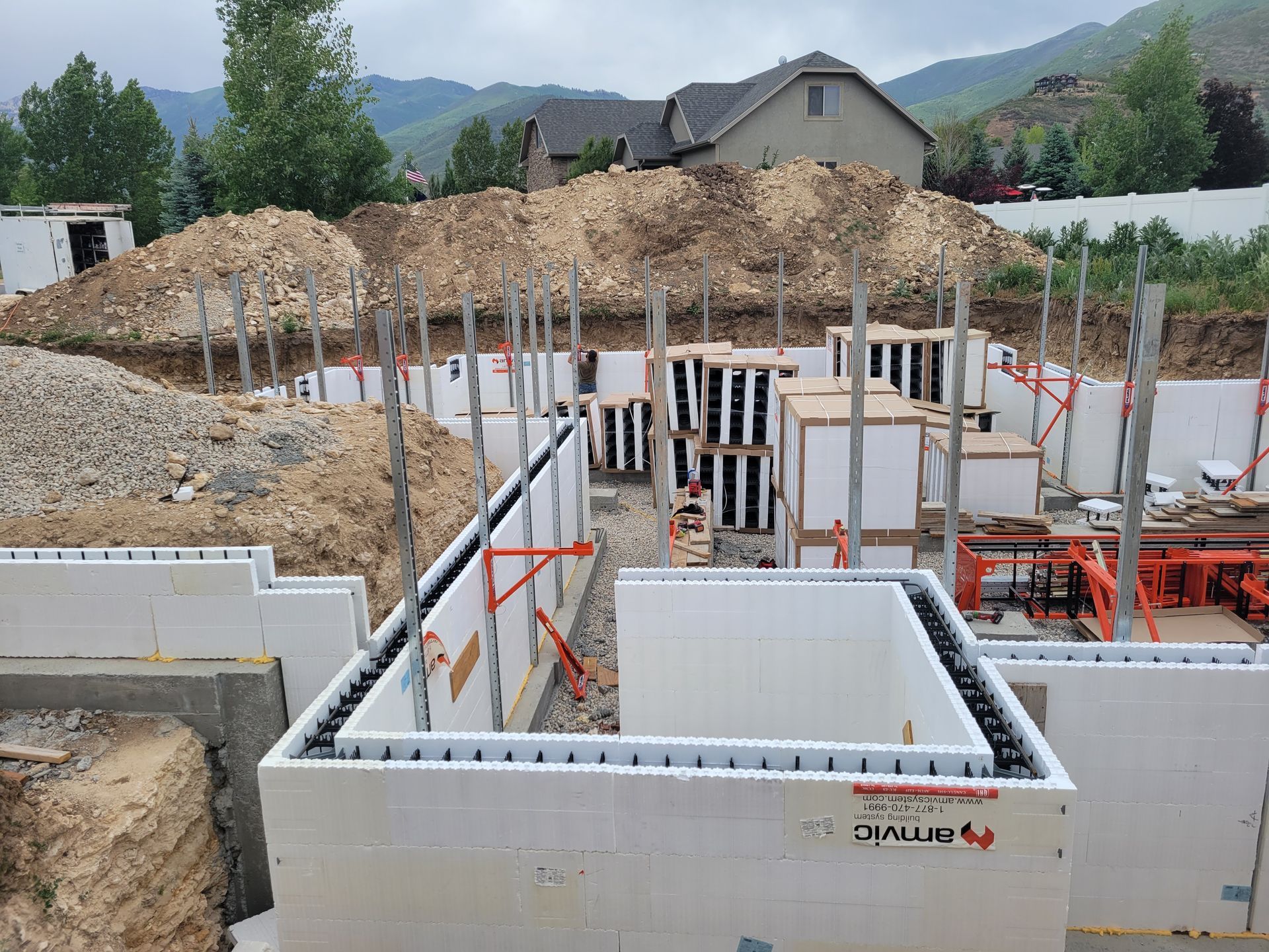 A construction site with a house in the background