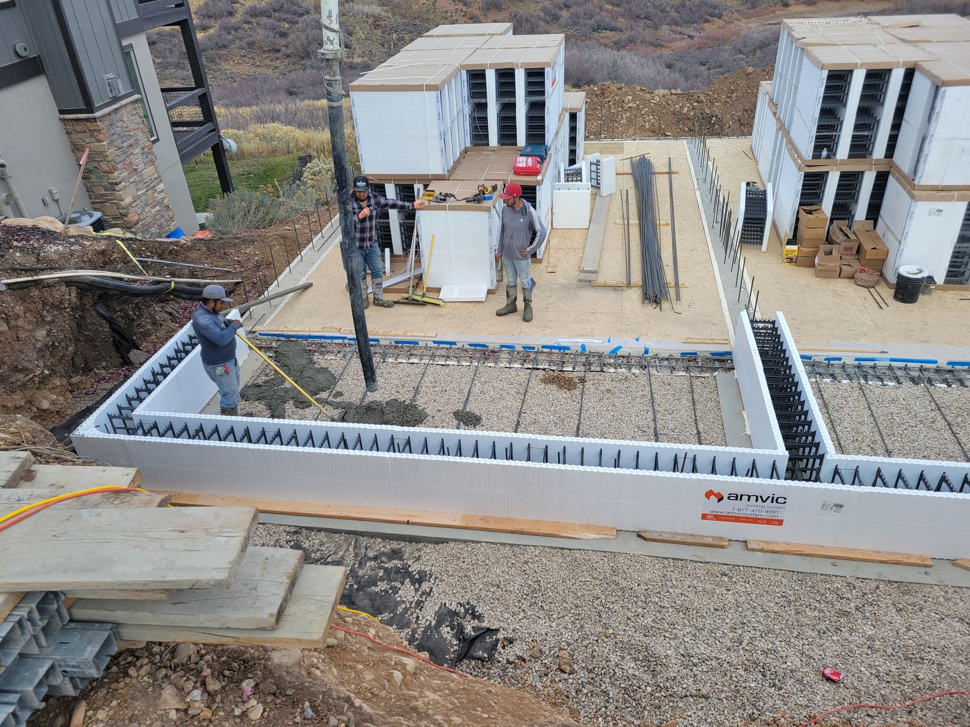 A group of construction workers are working on a house under construction.