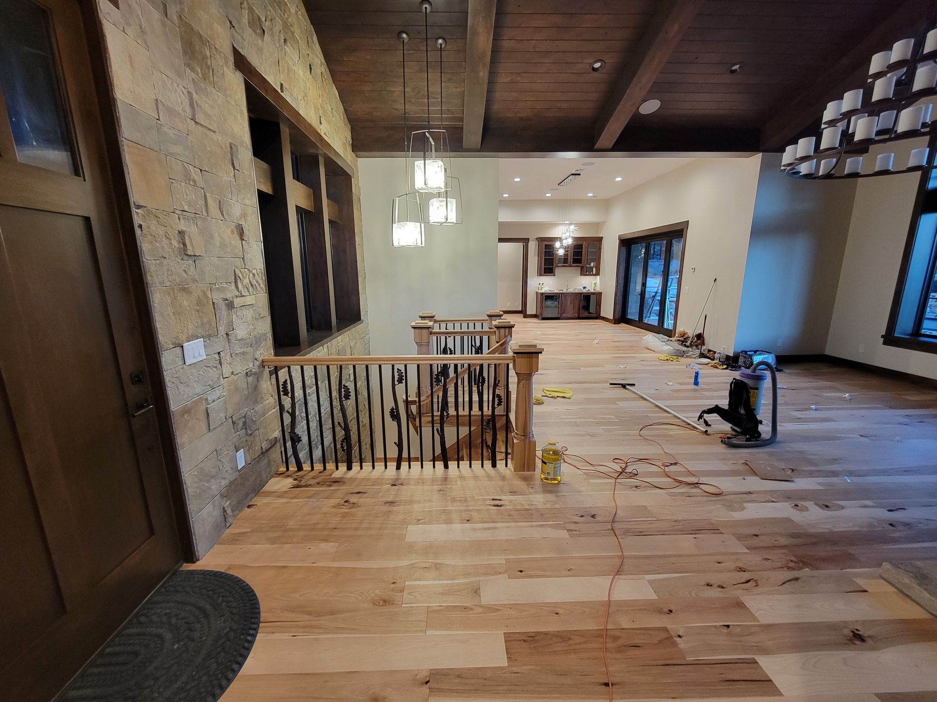 A large room with hardwood floors and a staircase.