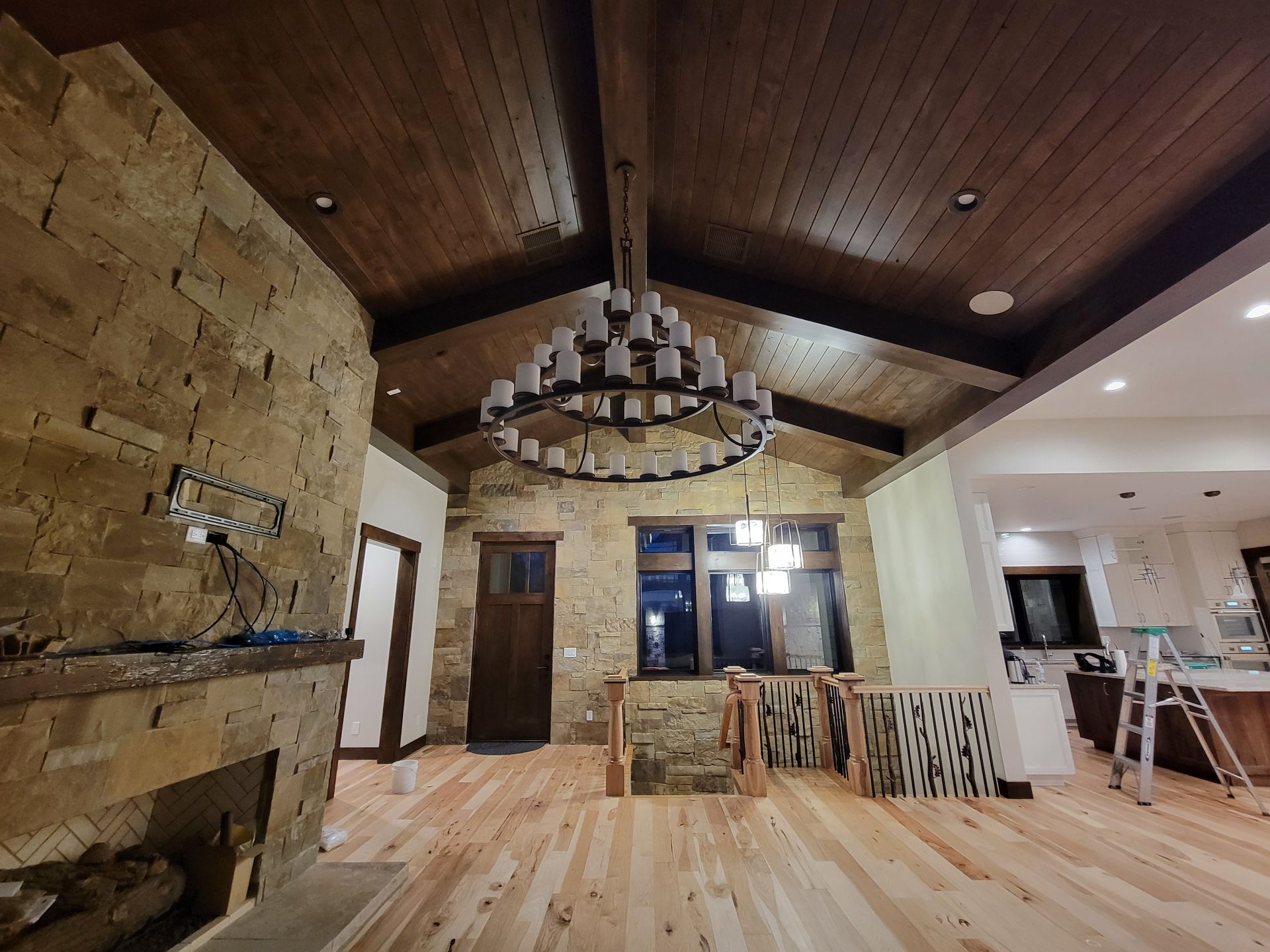 A living room with a fireplace and a chandelier hanging from the ceiling.
