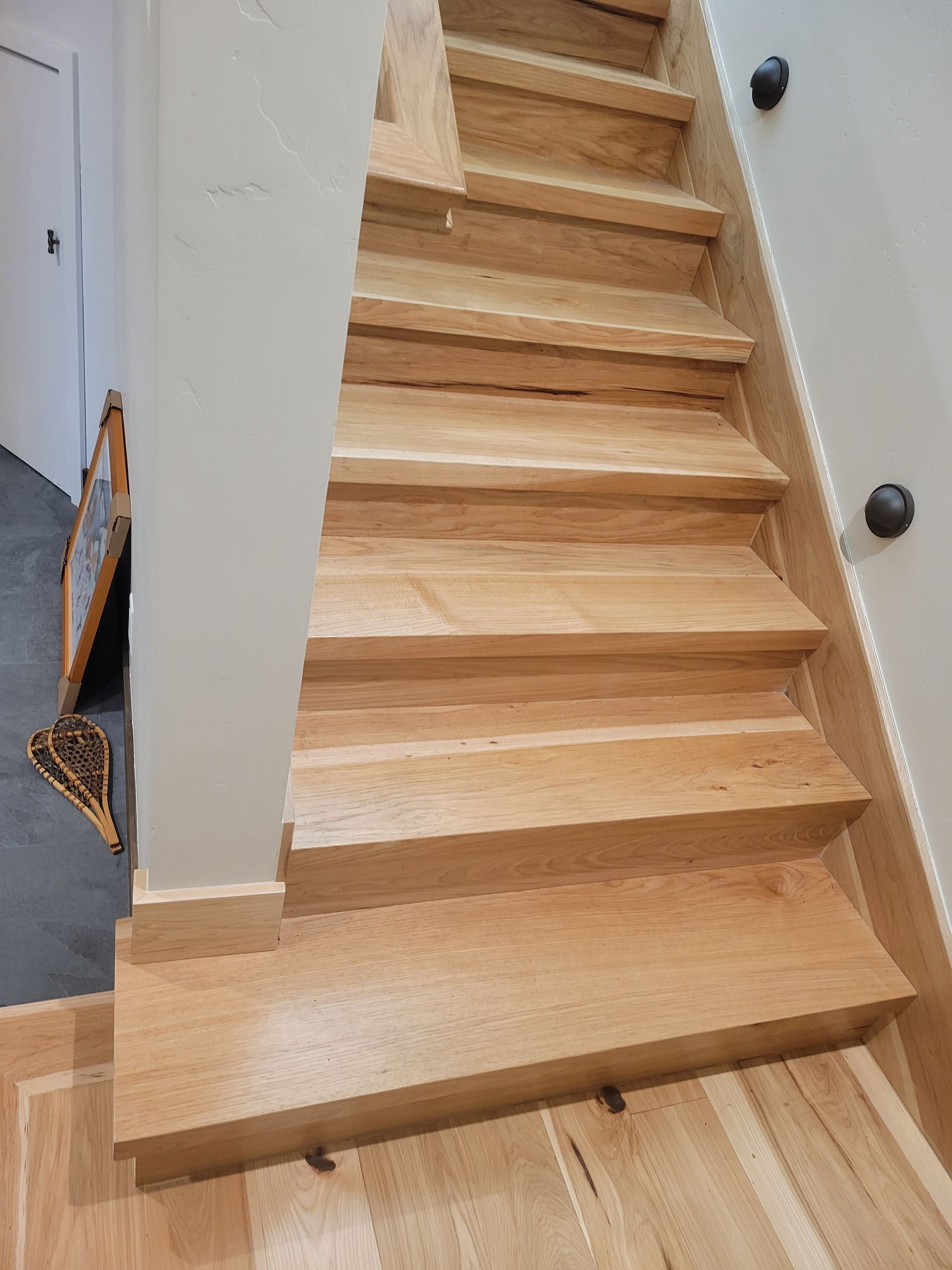 A set of wooden stairs leading up to a second floor in a house.